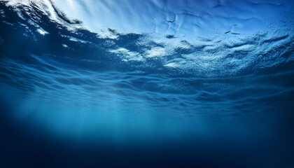 Underwater ocean scene with sunlight shining through the water surface