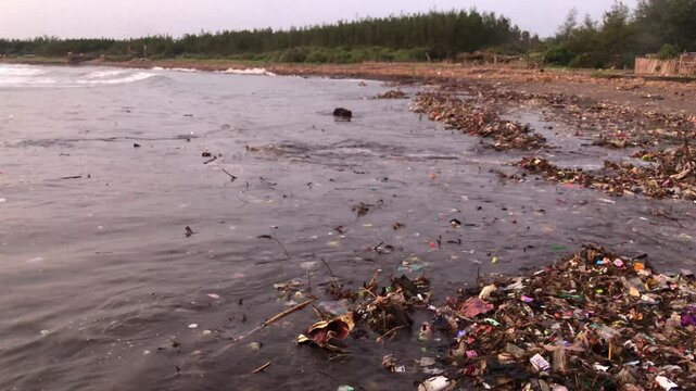 Ocean water and plastic trash island. Aerial view of pollution with plastic rubbish floating on the waves