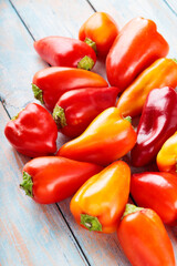 Ripe Red and Orange Bell Peppers Capsicum on Wooden Boards for Vegan Recipes