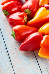 Ripe Red and Orange Bell Peppers Capsicum on Wooden Boards for Vegan Recipes
