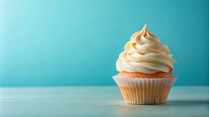 Delightful vanilla cupcake with swirled frosting on blue background, vanilla, cupcake, delightful, dessert, sweet, bakery
