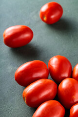 Ripe Plum Tomatoes on Green Background for Farm-to-Table Mediterranean Cuisine
