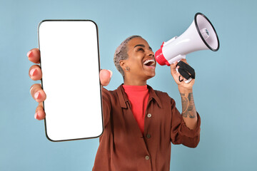 Confident individual holds a blank smartphone in one hand while passionately shouting into a megaphone. The lively background enhances the atmosphere of excitement and engagement.