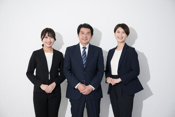 Multiple (3) smiling images in business suits, looking at camera, white background	