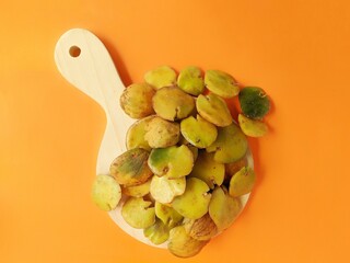 raw ripe jengkol food served on an orange background