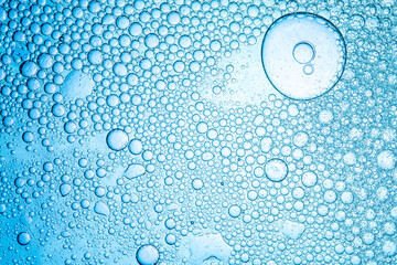 Close up macro of blue drink bubbles,Macro Oxygen bubbles in water on a blue background, concept...
