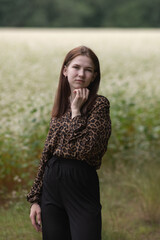 Portrait of a young beautiful long-haired girl in nature.