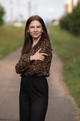 Portrait of a young beautiful long-haired girl in nature.