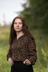 Portrait of a young beautiful long-haired girl in nature.
