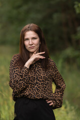 Portrait of a young beautiful long-haired girl in nature.