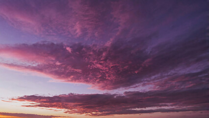 Panoramic view of stunning pink and purple sky at sunset. Beautiful nature background for girly wallpaper, header and banner.