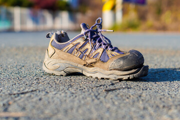 broken shoes on the asphalt