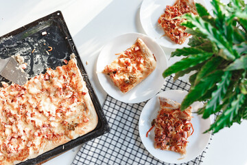 Flatbread pizza on wooden white table, top view. White bright background of home kitchen