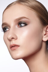 Fototapeta premium Beautiful Woman with an Fashion Hairstyle and Creative Makeup. Beauty face with trendy Make-up