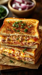 A deliciously stacked grilled cheese sandwich with melted cheese and herbs.
