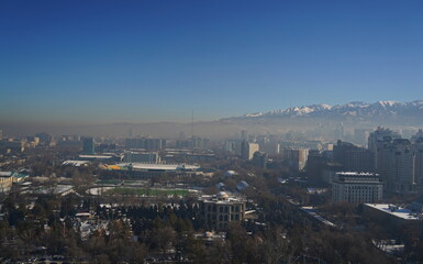 Almaty, Kazakhstan - 12.13.2024 : Heavy smog over the city. Residential buildings, commercial buildings and various architectures.