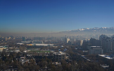 Almaty, Kazakhstan - 12.13.2024 : Heavy smog over the city. Residential buildings, commercial buildings and various architectures.