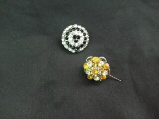 muslim shawl brooch with gems on black background, closeup. photo taken in malaysia

