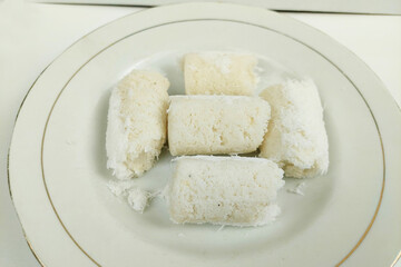 White rice cakes are neatly arranged on a plate on the table