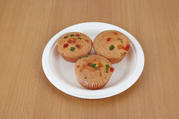 Home-made dessert, muffins with a berry, Chocolate almond mix of currants on a plate on a wooden table.