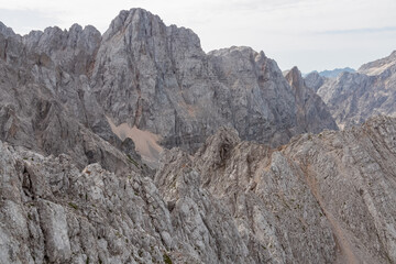 Panoramic view of rugged mountain ridge Skrlatica in majestic Julian Alps seen from top of summit Spik. Adventure and freedom in Triglav National Park, Slovenia, Slovenian Alps. Jagged alpine terrain
