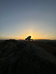 silhouette of a person doing yoga at sunset