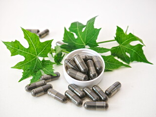 Herbal capsules placed in bottle caps