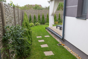Gutter Downspout Placement into the garden. Rain water use in your house