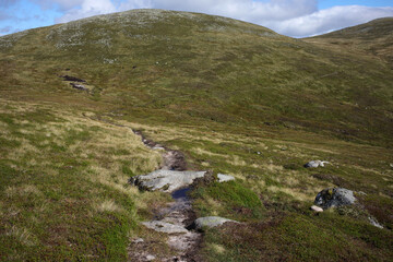 Trail and scenery between Carn a' choire Bhoidheach and Carn an t-sagairt mor munros - Loch Muick to Lochnagar path - Aberdeenshire - Scotland - UK