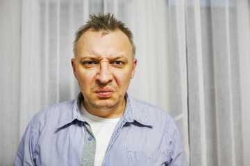 distorted face of sad and grieved very upset person, dissatisfied with his hard fate