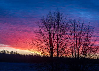 colorful sunrise sky outside the window, colorful play of light, shadows and reflections on the window glass, blurred outlines
