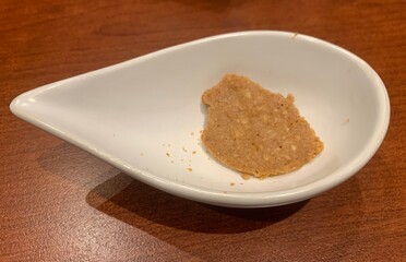 Incomplete cookies are placed in a clean white bowl