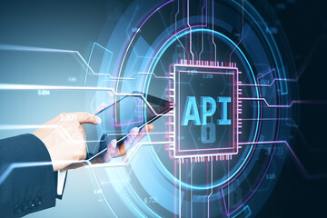 Futuristic API interface concept with businessman using tablet in digital environment.
