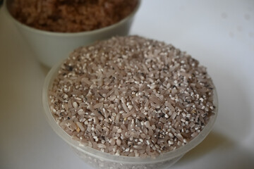 a bowl of riceberry rice : close-up pile of rice called riceberry rice, rice with high nutrients on white background. purple rice.