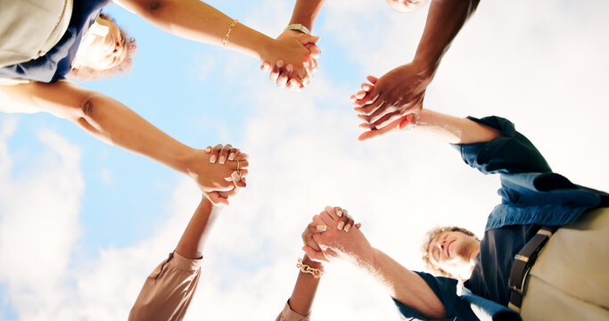 Friends, people and holding hands outdoor for teamwork, synergy or solidarity by sky. Group, support and community of students in circle for cooperation, association or collaboration at college below