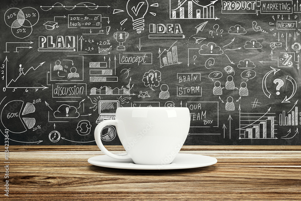 Poster white coffee cup on wooden desk with business sketches on blackboard background showcasing brainstor
