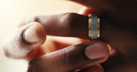 Person, hands and ring on finger for divorce, doubt and regret in relationship at home. Spouse,...