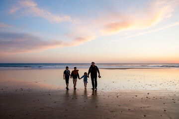 Portrait silhouettes of three children and dad happy kids with father on beach at sunset. happy family, Man, two school boys and one little preschool girl. Siblings having fun together. Bonding