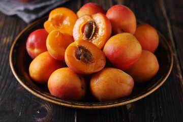 Fresh ripe apricots in bowl in rustic style	