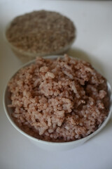 a bowl of riceberry rice : close-up pile of rice called riceberry rice, rice with high nutrients on white background. purple rice.