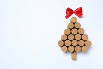 Christmas tree shaped wine corks on white background. Top view with copy space for text
