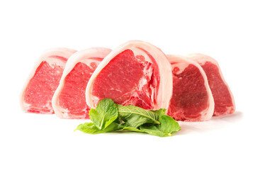 Fresh uncooked lamb loin chops and mint leaf on white background. High quality meat product cut by butcher in perfect size for cooking. Food supply chain and agriculture industry.