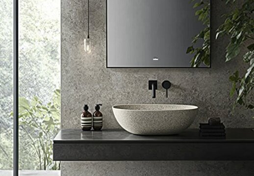 A bathroom sink with a plant in front of it