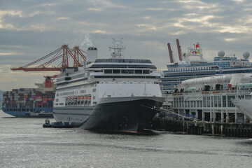 Classic luxury cruiseship cruise ship liner Volendam or Zaandam arrival into Vancouver, BC Canada after Alaska cruise with scenic harbor coast view and marine vessels