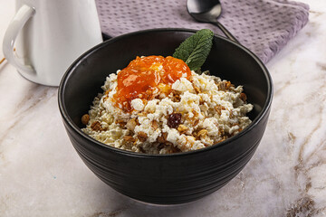 Curd with granola and orange jam