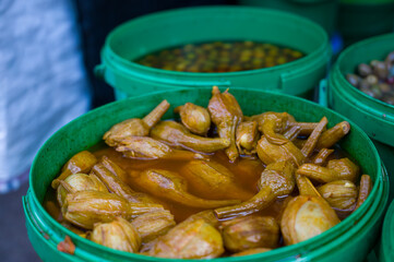 Wide selection of pickled olives and aubergines in a food stall a traditional market