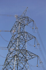 Powerline cables over the blue sky	
