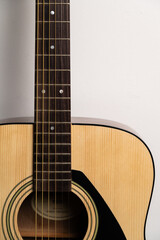 wooden guitar close-up on a white background