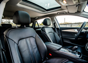 Photo modern car interior features comfortable front seats and headrests with sleek black leather upholstery, ensuring a luxurious ride.