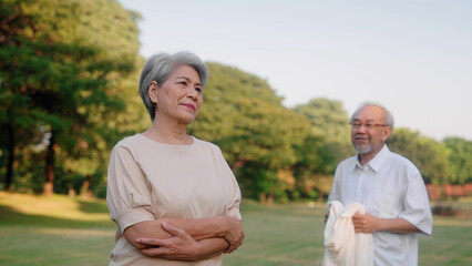 Retired husband is walking to his wife in a park, Elderly retirement family taking care of each other and outdoor concept